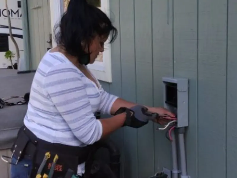 Licensed electrician wiring an exterior subpanel in Cut Off